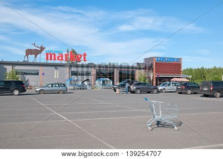 LAPPEENRANTA, FINLAND - JUNE 15, 2016: Laplandia Market near Finnish-Russian border. People put purchases into the car.