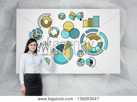Businesswoman delivering presentation with business pie charts drawn on whiteboard hanging on abstract patterned wall