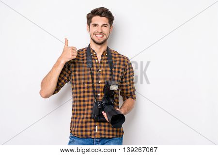 Young Happy Photographer Holding Camera And Showing Thumb Up