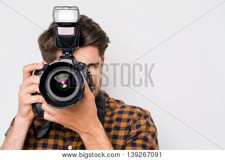 Young Man Focusing With Digital Camera  Isolated On White Background