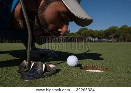golf player blowing ball in hole. concept of cheating and success