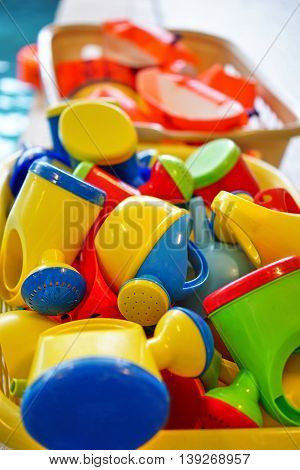 Baby watering pots in many colors in a pool