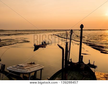 Fishing boat coming back home , sunset light
