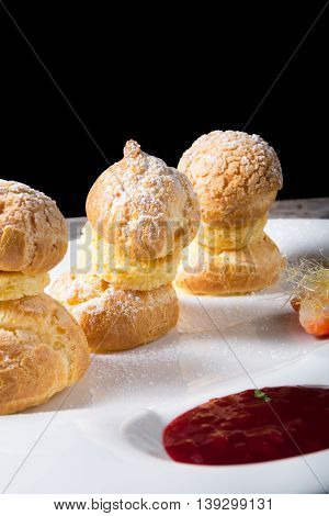 Sweet eclairs dessert served on w hite plate