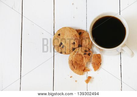Cookies and coffee on white wooden palette