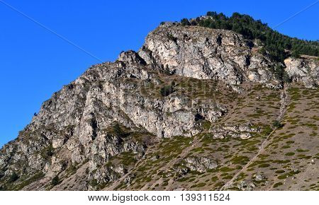 Mountain cliff, sunny morning. Near the top of Elbrus. On the border of the Republic of Kabardino-Balkaria and Karachay-Cherkessia. Photo taken on:  November 3 Sunday, 2013