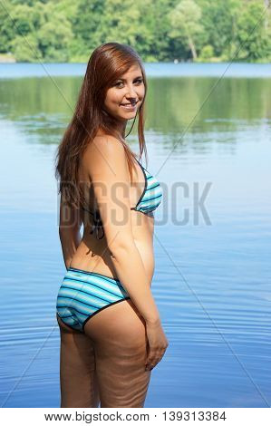 young woman wearing triangle bikini set at bathing lake