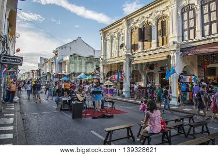 PHUKET THAILAND NOVEMBER 01 2015: Tourists shop at the old town night market (walking street) among old building Chino Portuguese style street of Phuket town in Phuket Thailand.