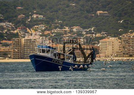 Palamos, Catalonia may 2016: Fishing motor boat fishing trawls on Mataro bay.