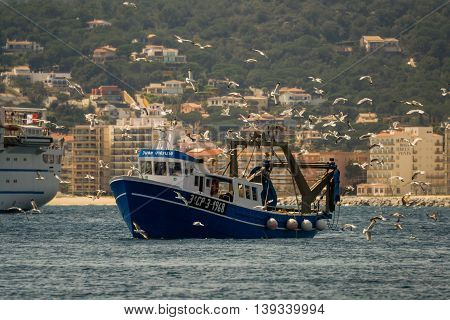 Palamos, Catalonia may 2016: Fishing motor boat fishing trawls on Mataro bay.