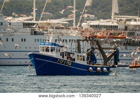 Palamos, Catalonia may 2016: Fishing motor boat fishing trawls on Mataro bay.