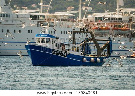 Palamos, Catalonia may 2016: Fishing motor boat fishing trawls on Mataro bay.