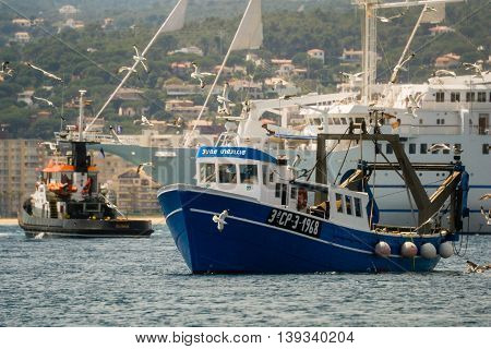 Palamos, Catalonia may 2016: Fishing motor boat fishing trawls on Mataro bay.