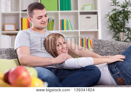 Husband and woman enjoying on sofa, close up