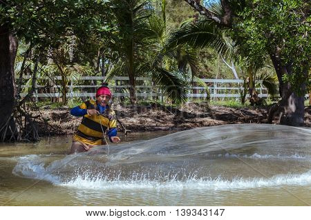 Tuaran, Sabah, Malaysia - June 7, 2016: Unidentified fisherman catch fish by throwing net.