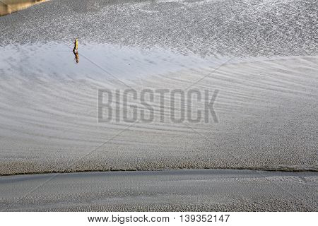 CANNING TOWN, WEST BENGAL, INDIA - FEBRUARY 13: During low tide the water in the river Malta falls so low that people walk to the other shore in Canning Town, India on February 13, 2014.