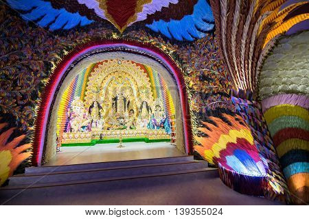 KOLKATA INDIA - OCTOBER 18 2015 : Night image of decorated Durga Puja pandal shot at colored light at Kolkata West Bengal India. Durga Puja is biggest religious festival of Hinduism.