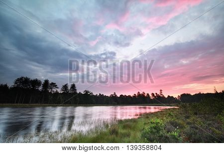 purple sunrise over wild forest lake Drenthe Netherlands