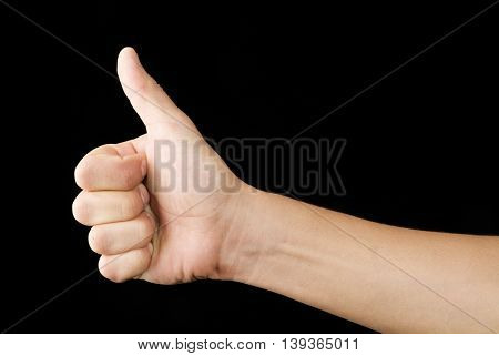 a hand with a thumb up with black background