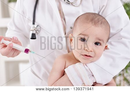 A Doctor Giving A Baby An Injection