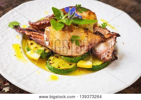 Grilled Squid With Lemon And Zucchini On Wooden Background