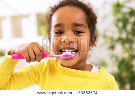 Little Beautiful African Girl Brushing Teeth