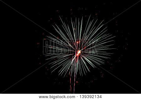 Green and Red Fireworks explode in the night