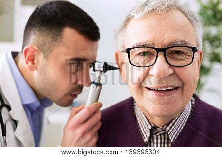 Senior patient visit otologist ear examining, close up