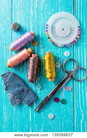 Set for sewing and needlework on a wooden board in Shabby Chic style - thread seam ripper scissors buttons pins