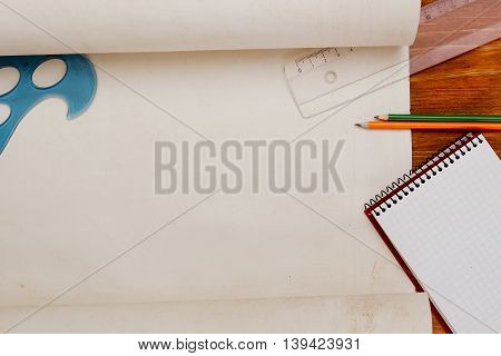 Roll of paper for drawings on a wooden table