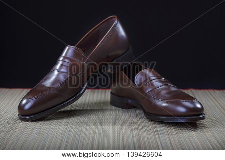 Footwear Concepts. Pair of Stylish Modern Calf Leather Brown Penny Loafers Shoes.Closeup Shot. Horizontal Image Orientation