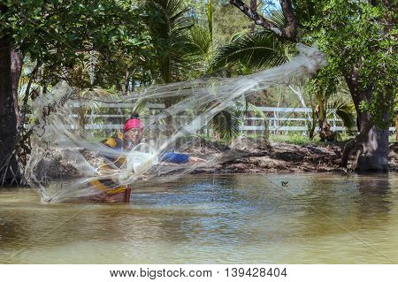 Tuaran, Sabah, Malaysia - June 7, 2016: Unidentified fisherman catch fish by throwing net.
