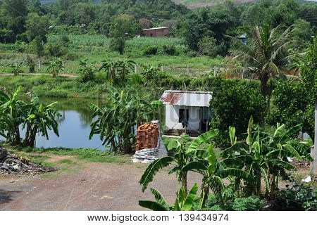Vietnamese countryside with house next to the fishing pond