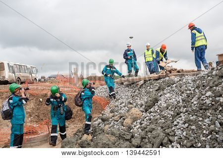 Tobolsk, Russia - July 15. 2016: Sibur company. Construction of plant on processing of hydrocarbonic raw materials. Photographers shoot workers on construction site