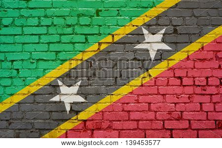 Brick wall with painted flag of St Kitts and Nevis