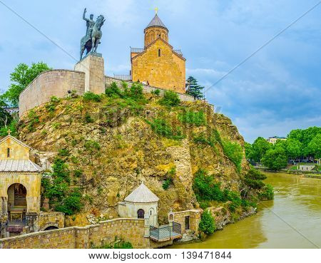 The rocky cliff in Tbilisi city center is occupied with Metekhi medieval Church and Vakhtang Gorgasali monument Georgia.