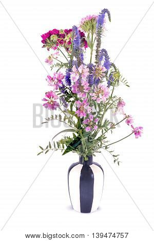 Bouquet of wild flowers in striped vase