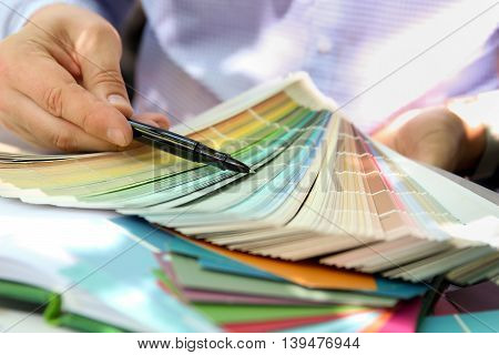 sales agent choosing color samples for design project.