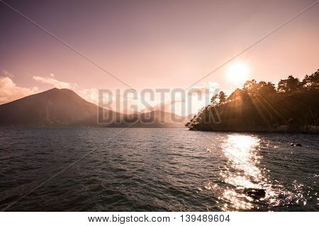 Landscape of San Pedro volcano and Lake Atitlan seen on sunset Guatemala