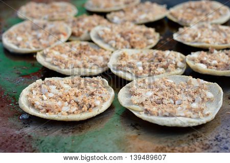 Mini tostadas with toppings of meats and veggies - traditional street food at local markets in Quetzaltenango Guatemala. Shallow depth of field
