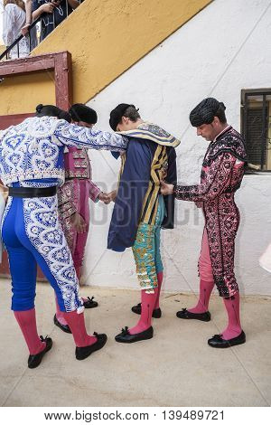 Jaen SPAIN - October 17 2010: Toreador putting itself the walk cape in the alley before going out to fight typical and very ancient tradition in Jaen Spain