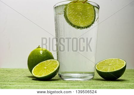 Glass with cold sparkling mineral water lime and lemon seltzer