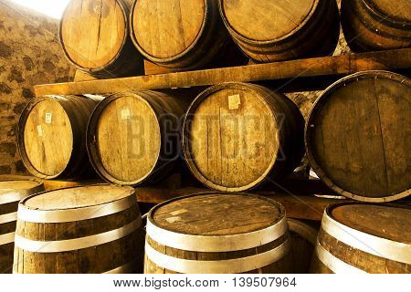 Wine barrels stacked in the old cellar of the winery.