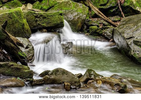 Small Cascade On The River Among Bouders