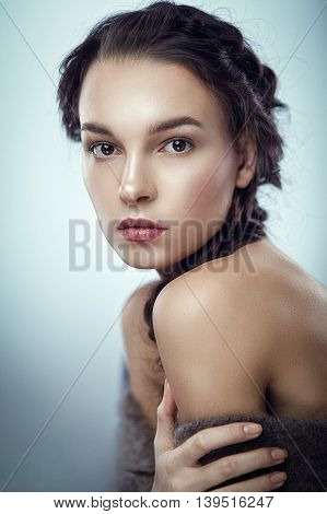 Fashion portrait of gorgeous young brunetee woman.Chaos hair style with braid. Shallow depth of field