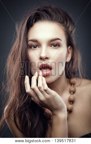 Fashion portrait of gorgeous young brunetee woman. Shallow depth of field. Chaos on head hairstyle