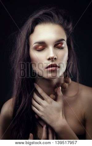Fashion portrait of gorgeous young brunetee woman. Shallow depth of field. Chaos on head hairstyle