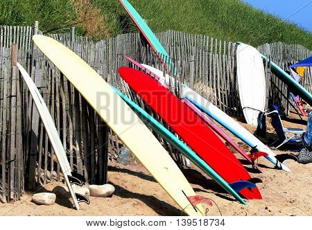 Surfboards rest against a fence in Ditch Plains Montauk, NY