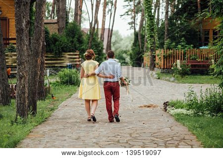 Lovers Hold Hands And Walk In The Park