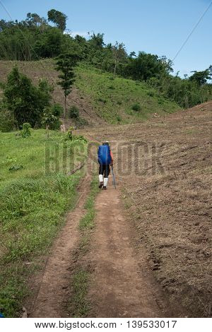 Man Traveler with big backpack mountaineering Travel to the Pre To Lo Su or Pi Tu Kro waterfall heart-shaped waterfall Umphang Tak ,Thailand.